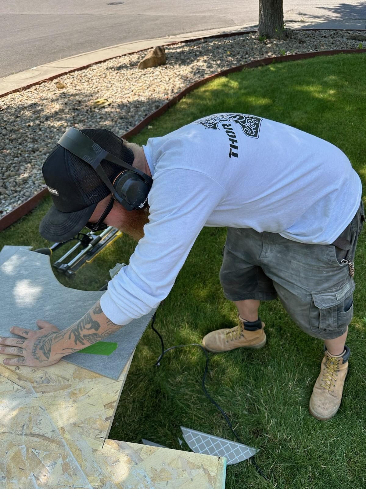 The owner of Thor Builders cutting siding on a job site in Southern Oregon